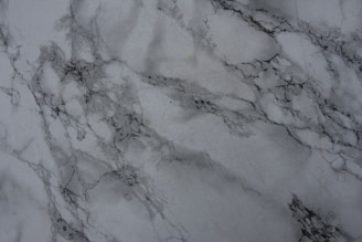 A close-up of elegant marble tiles arranged in a modern pattern, showcasing texture and finish.