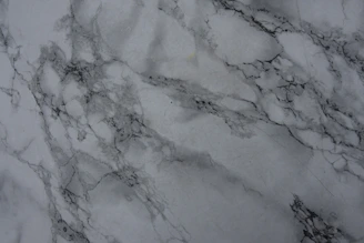 Close-up of a finely polished marble surface with subtle veins in soft gray tones.