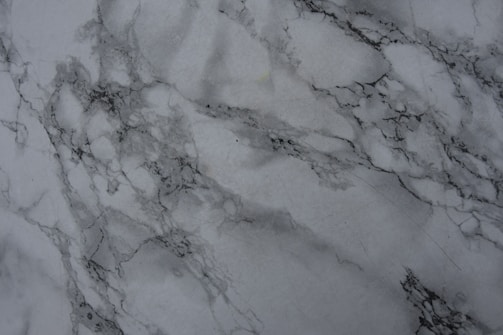 Elegant marble texture background with subtle lighting highlighting natural stone veins.