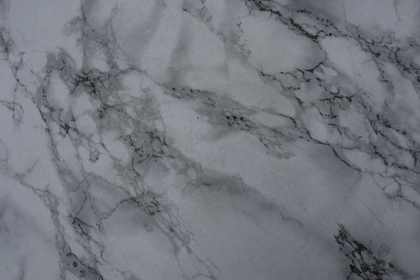 Close-up of a polished white quartz slab with subtle grey veining.