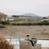 man using laptop on chaise lounge outdoor