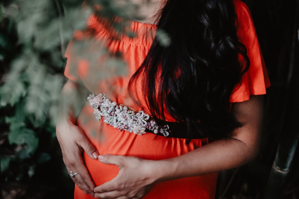 pregnant woman holding her tummy