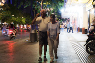 A young couple exploring a vibrant city street on their honeymoon package.