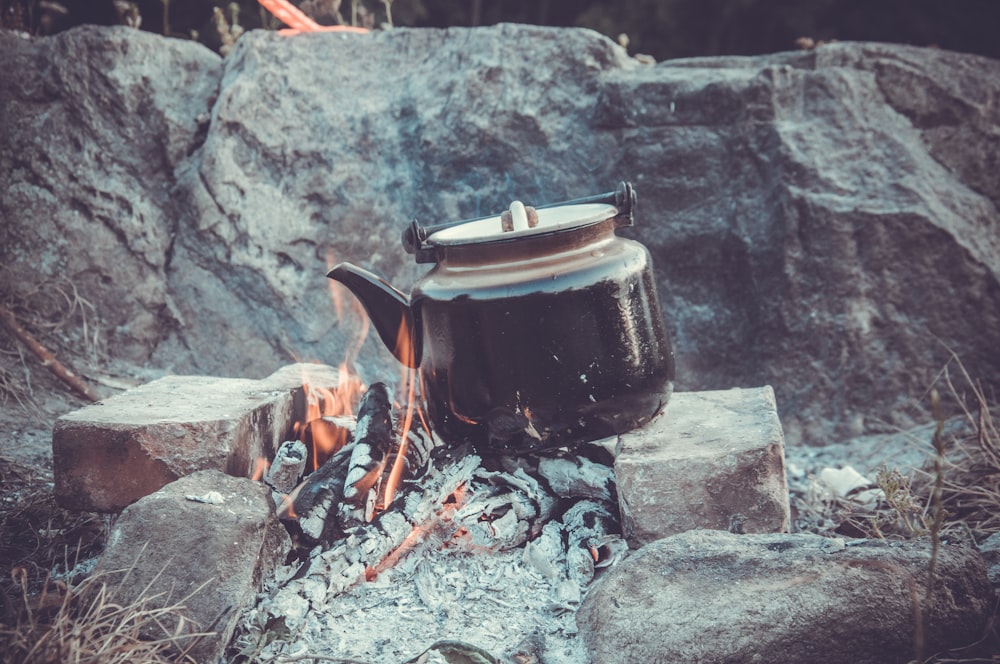 black kettle on gray rock