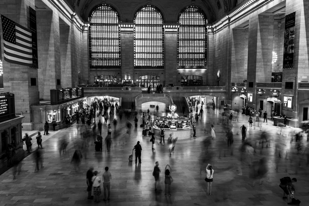 grayscale photo of people inside building