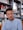 man wearing eyeglasses and blue shirt inside coffee shop