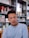 man wearing eyeglasses and blue shirt inside coffee shop
