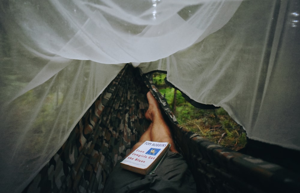 person lying on hammock