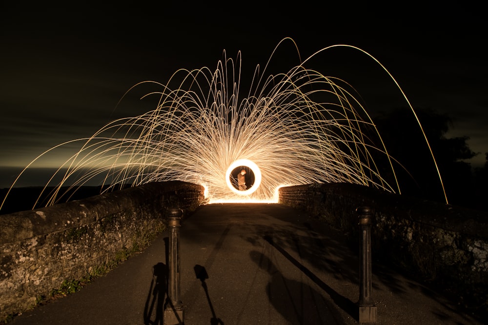 steel wool photography of standing man at night