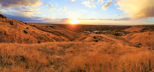 Sunset over the rolling hills and farms typical of southern Brazil's countryside.