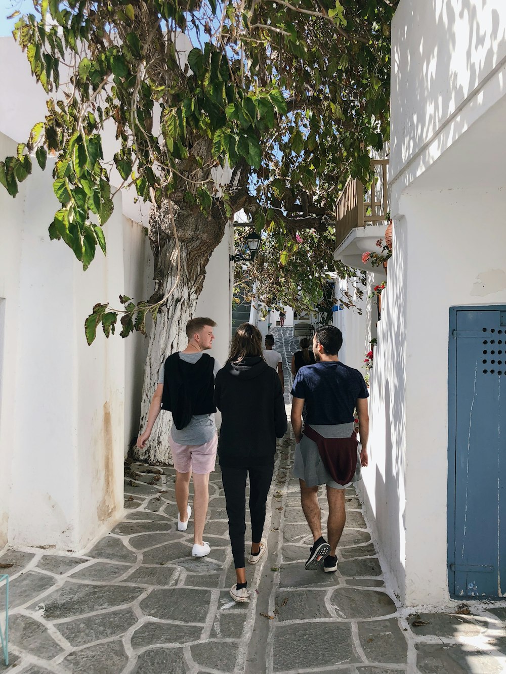 three person walking in hallway