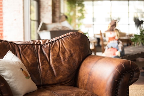 white throw pillow on brown leather armchair