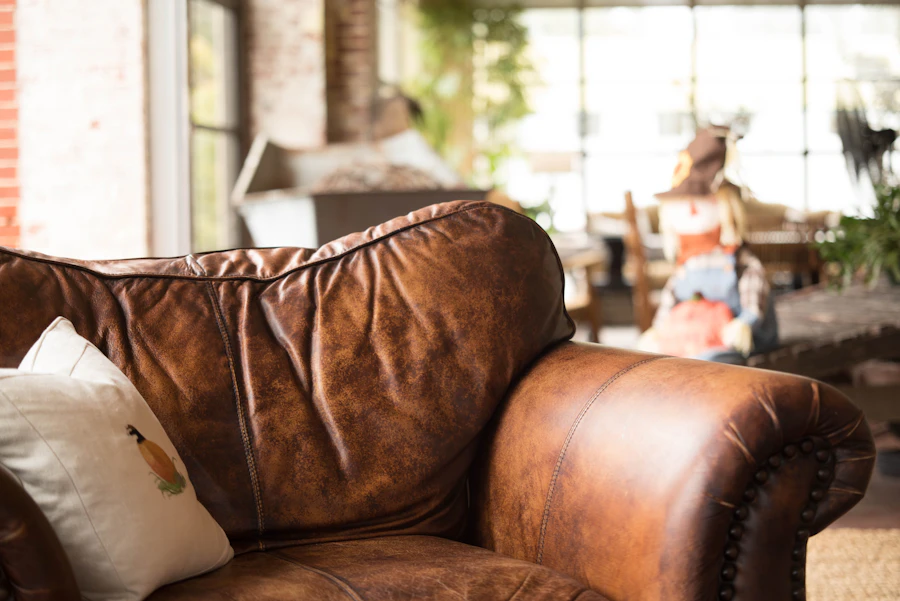 Patinated brown leather sofa in warm light