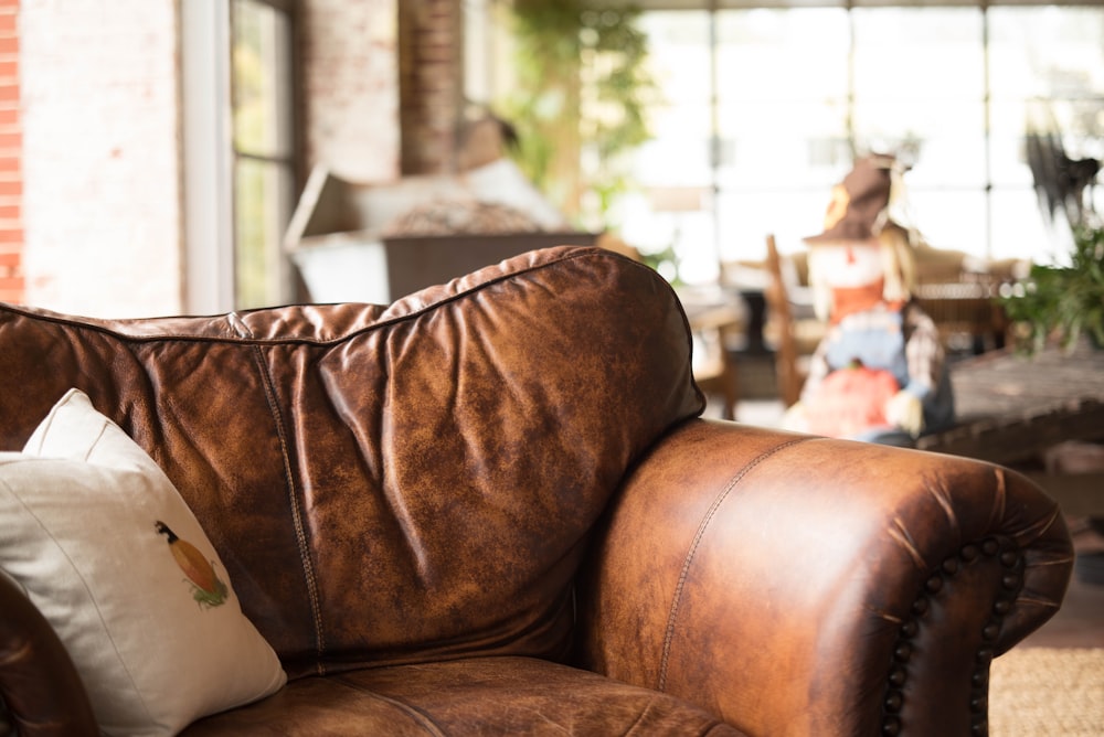 white throw pillow on brown leather armchair