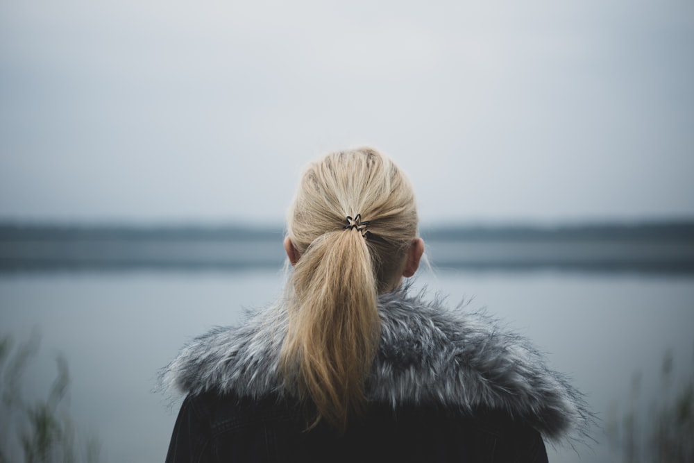 selective focus photography of woman's back