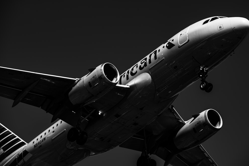 grayscale photo of white and black airliner