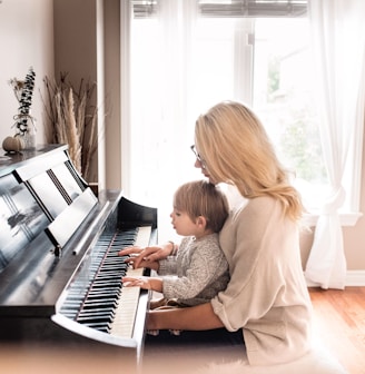 woman and child playing piano