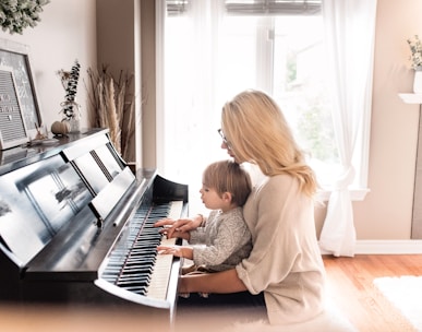 woman and child playing piano