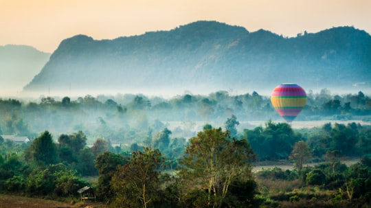 time lapse photography of flying hot air balloon in Vang Vieng Laos