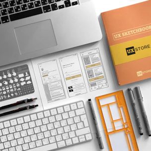 An artistic arrangement of graphic design assets including logos, icons, and mockups on a clean workspace.