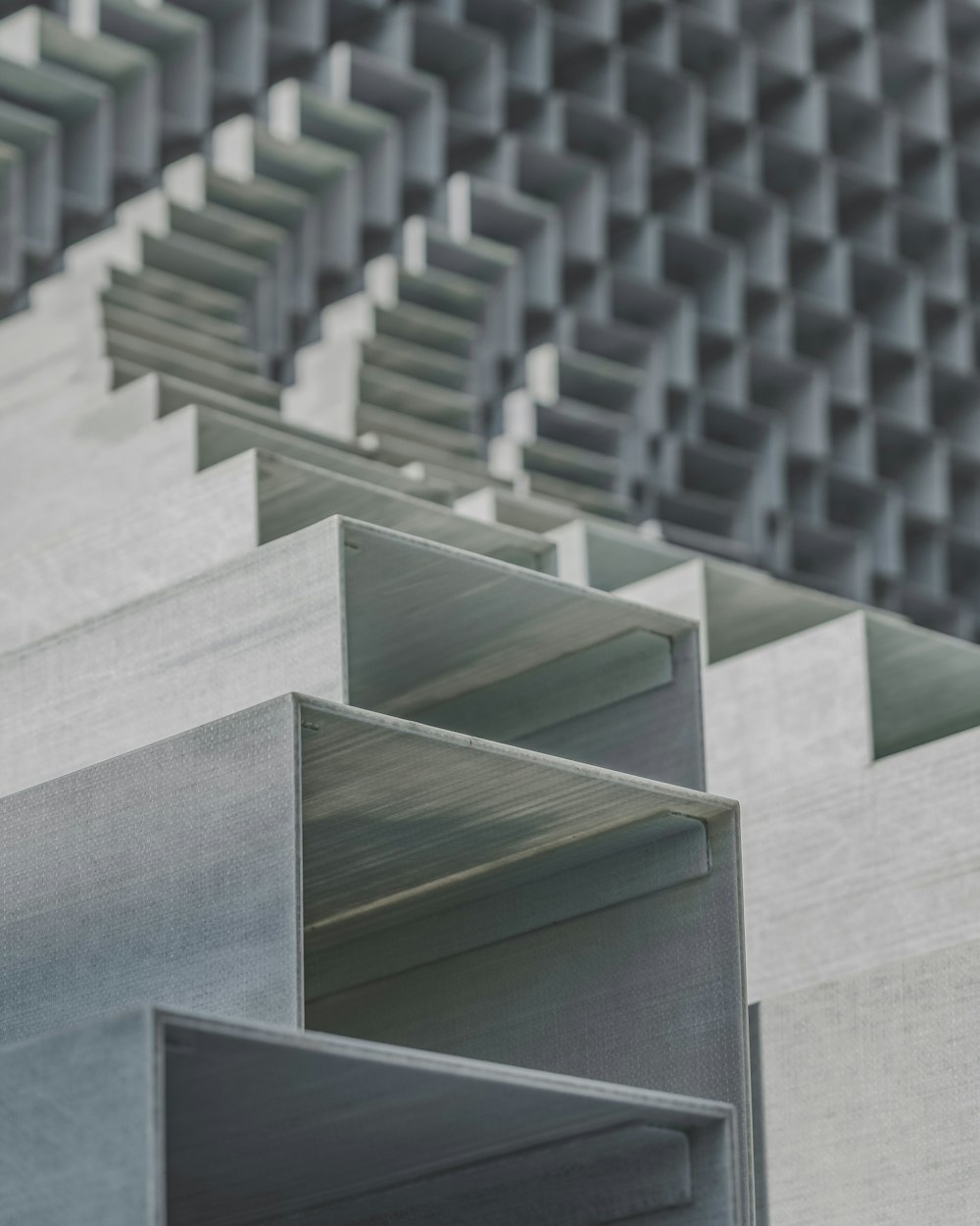 a close up of a metal structure with a wall in the background