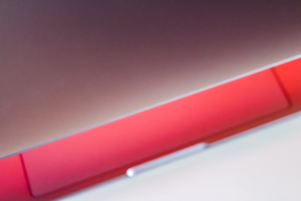 a close up of a red object on a white surface