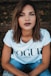 woman in white Vogue t-shirt and blue jeans