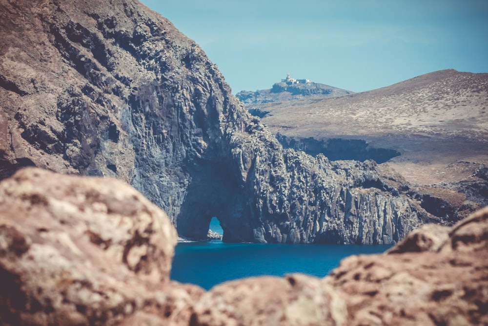 blue water cove covered by rock walls