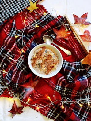 A cozy kitchen scene with a bowl of creamy oatmeal topped with fresh fruits.