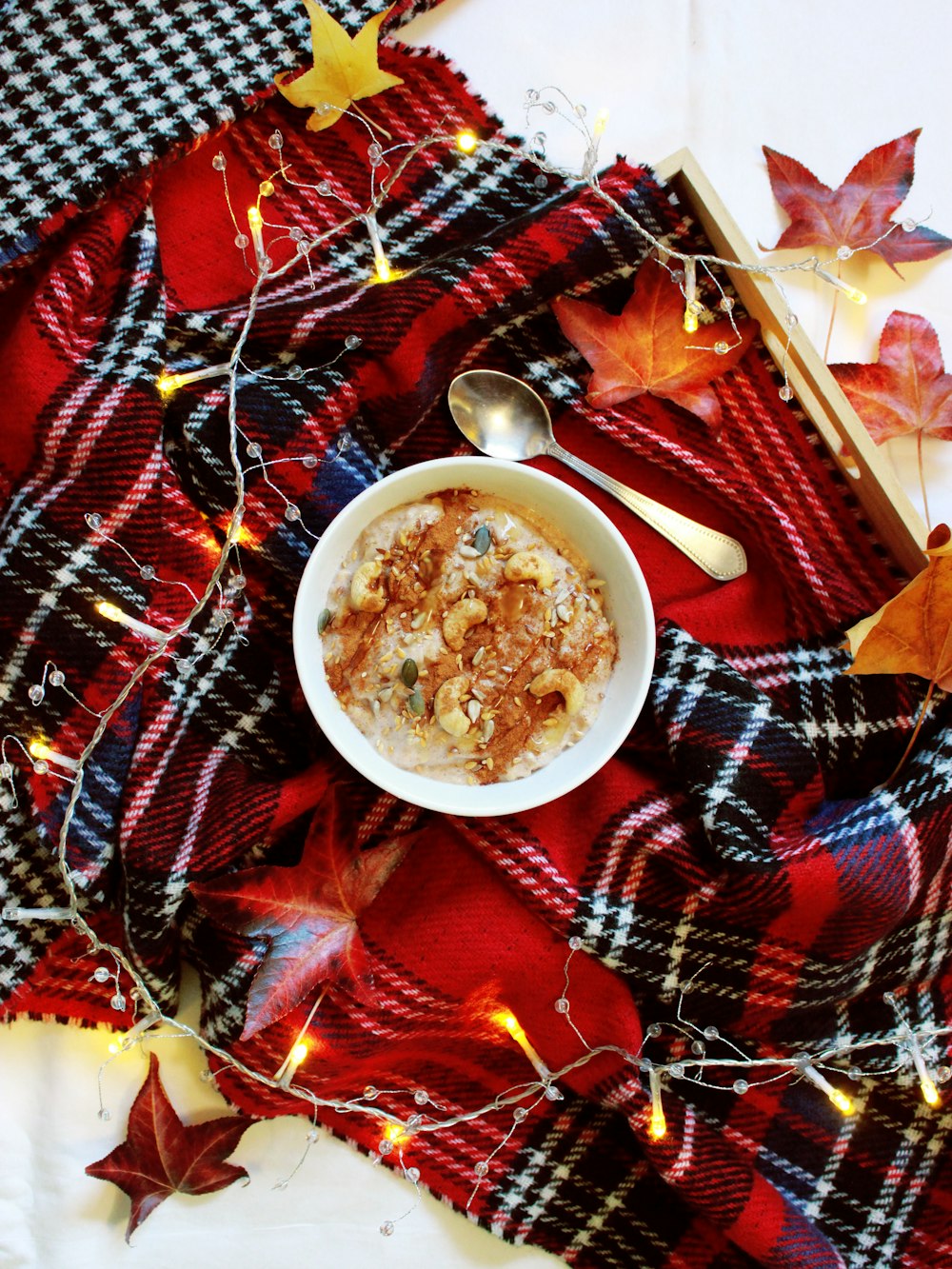 cereals with nuts in bowl near gray stainless steel teaspoon