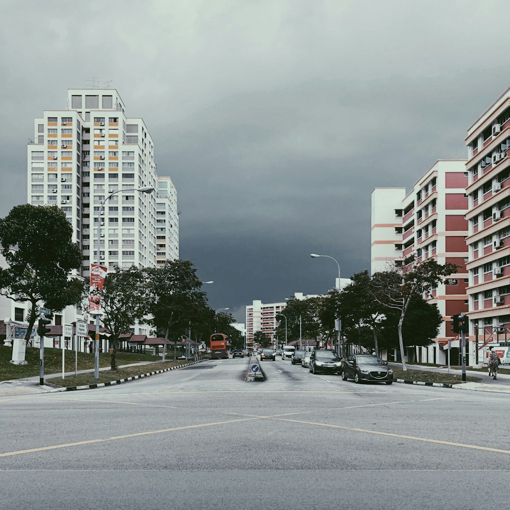 few cars on road near high-rise buildings