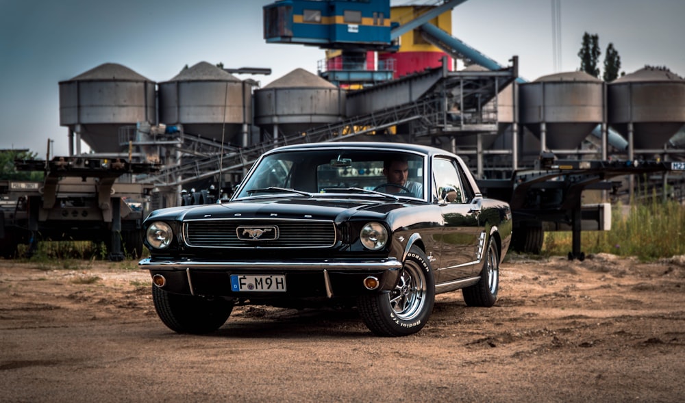 black Ford Mustang near factory