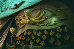 Artisan hands carefully inspecting a freshly printed divine statue under warm light