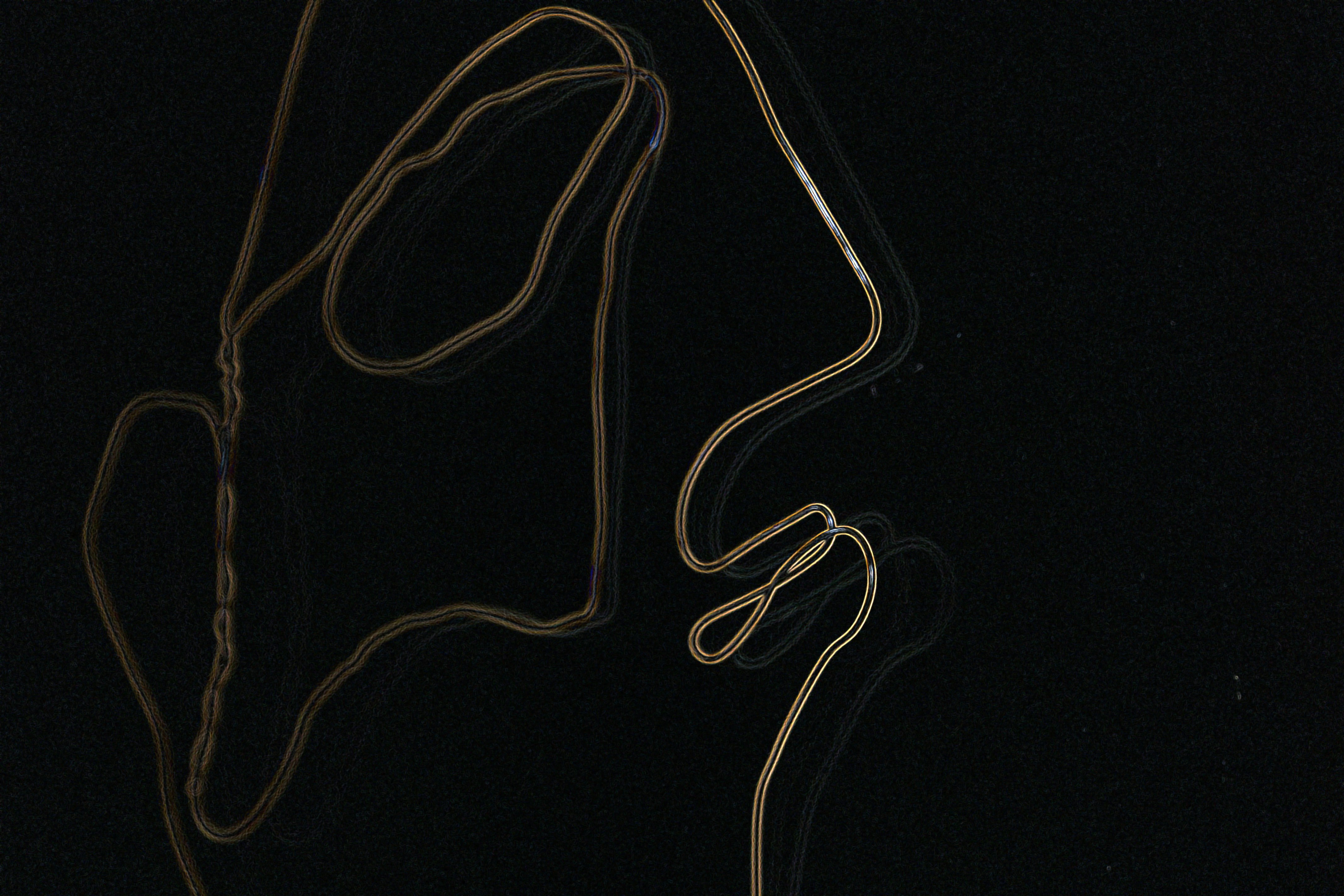 silver-colored necklace on black background