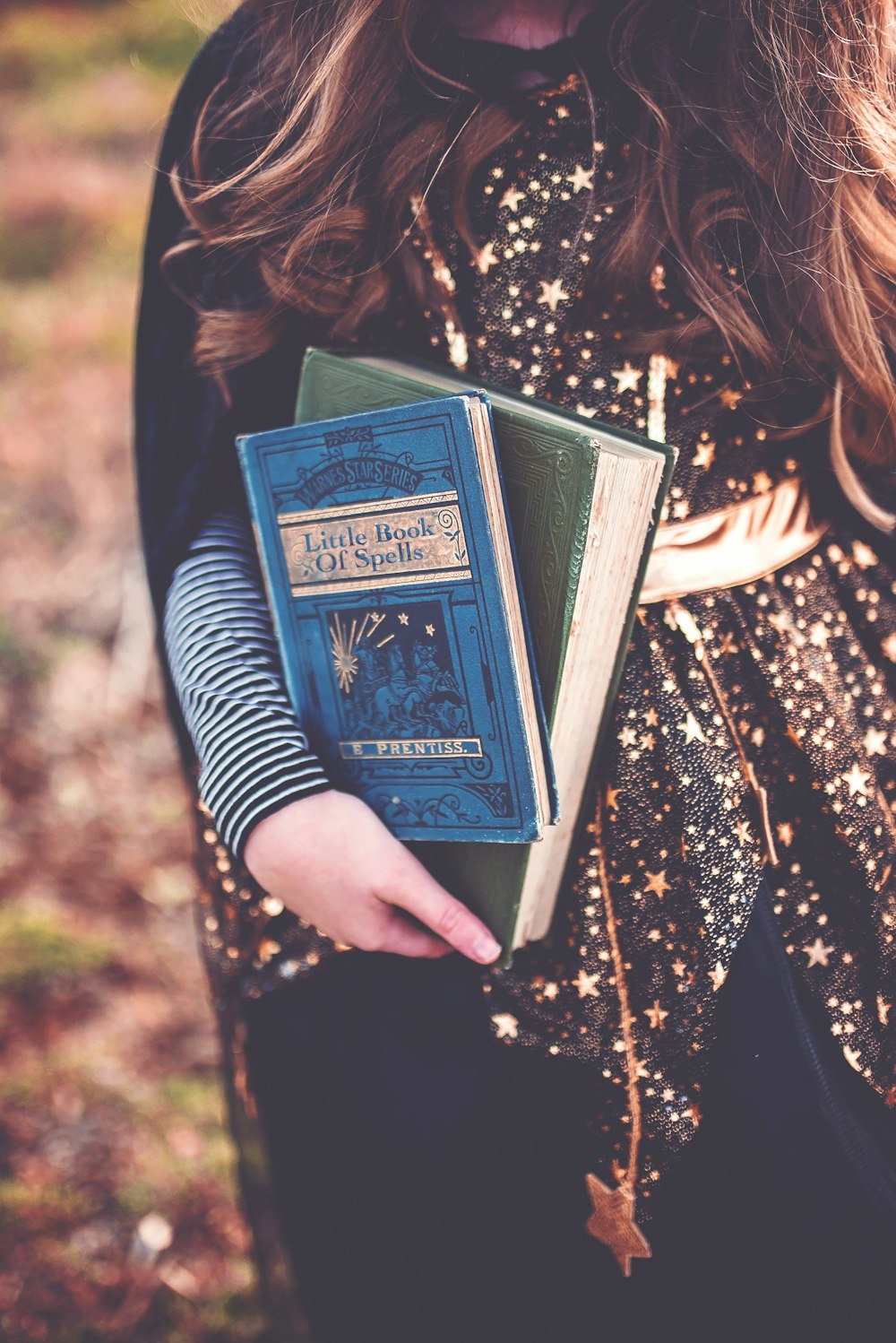 person holding two books