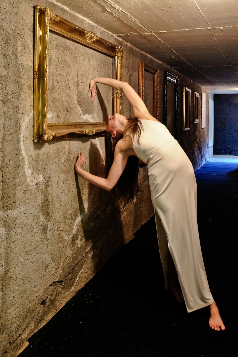 woman bending with body leaning on wall \