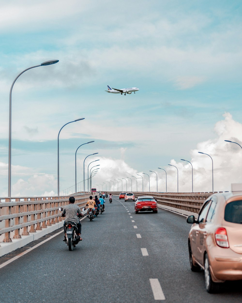 motorcycles and vehicles on road during daytime