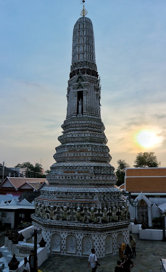 white landmark during daytime in Wat Arun Ratchawararam Ratchawaramahawihan Thailand