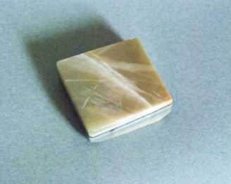 brown game tile on gray surface