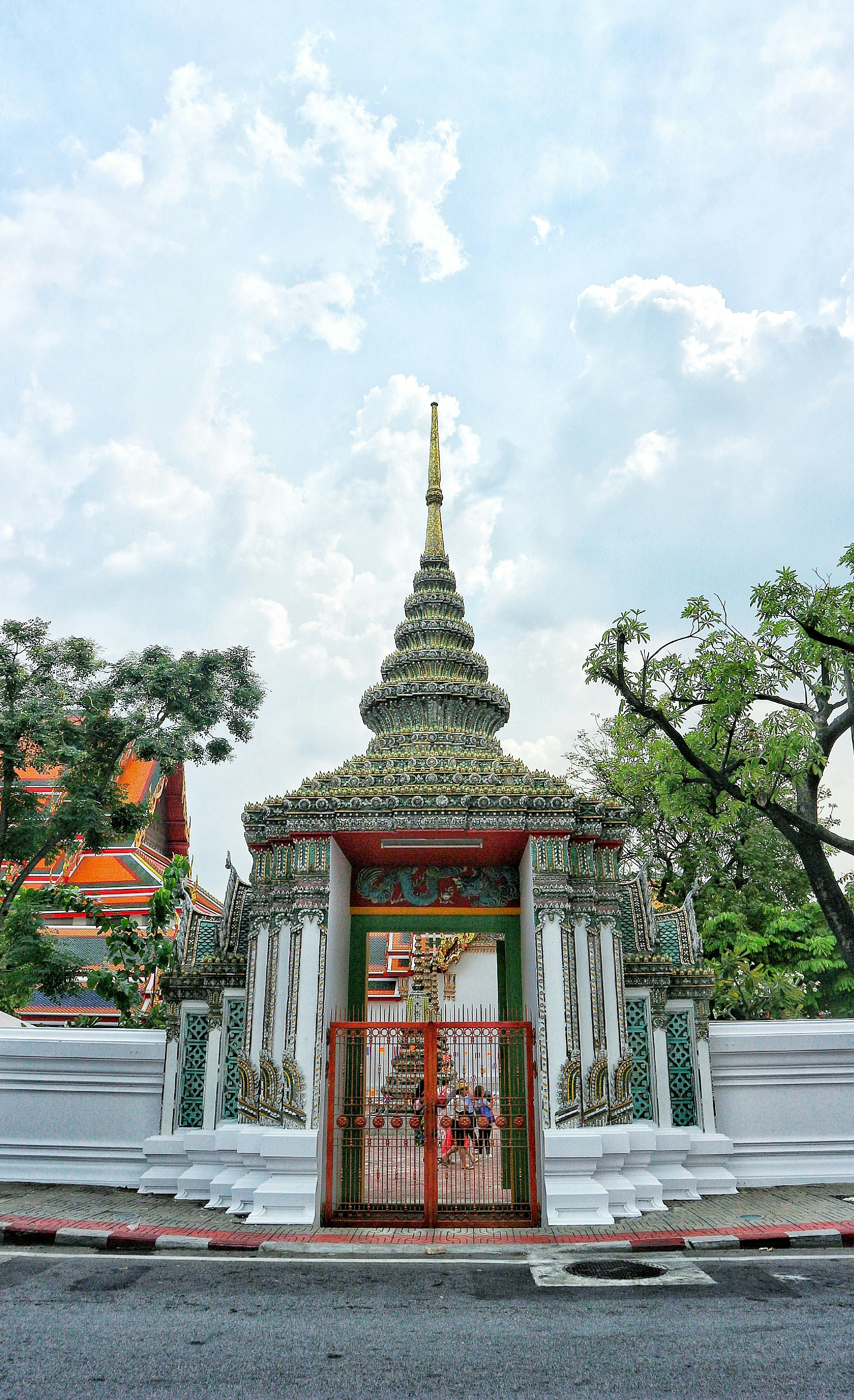 white and gray temple under blue cloudy sky at daytime