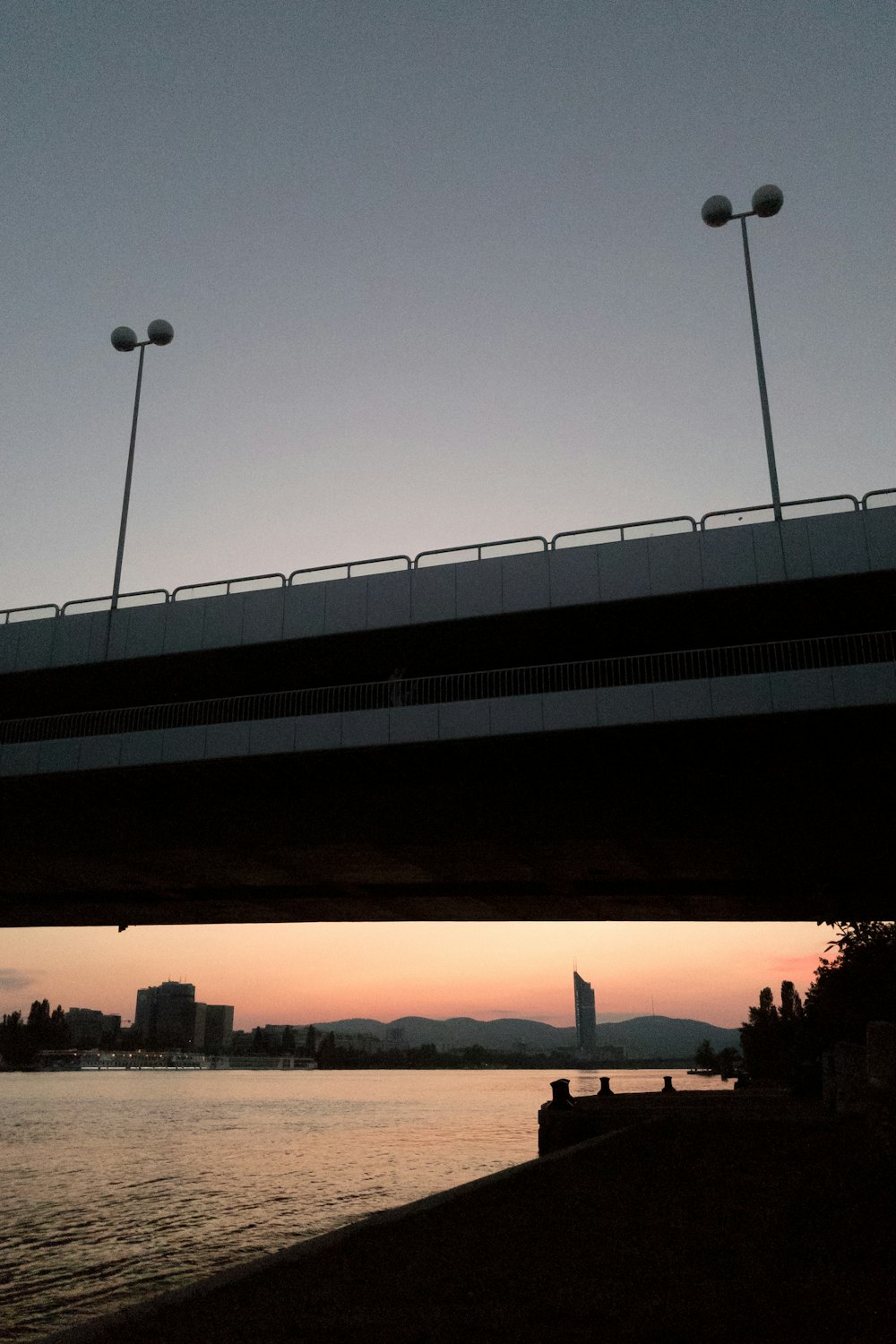 sunrise over bridge and body of water horizon