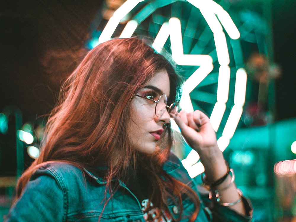 woman touching eyeglasses