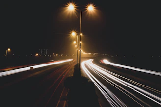 time lapse photo of cars passing by during nighttime