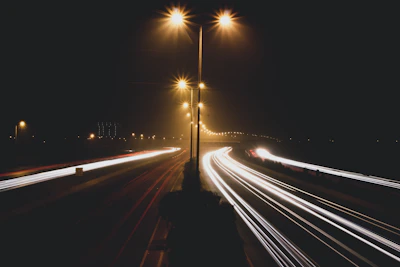time lapse photo of cars passing by during nighttime