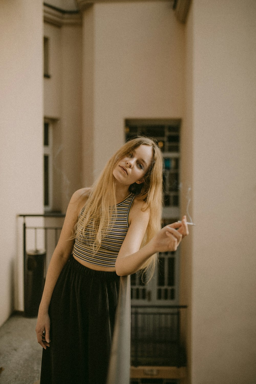 mujer sosteniendo un cigarrillo blanco