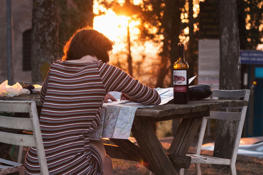 woman writing on brown wooden farm table