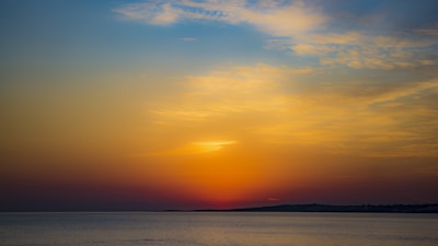 A serene pastel sunset over a calm ocean.