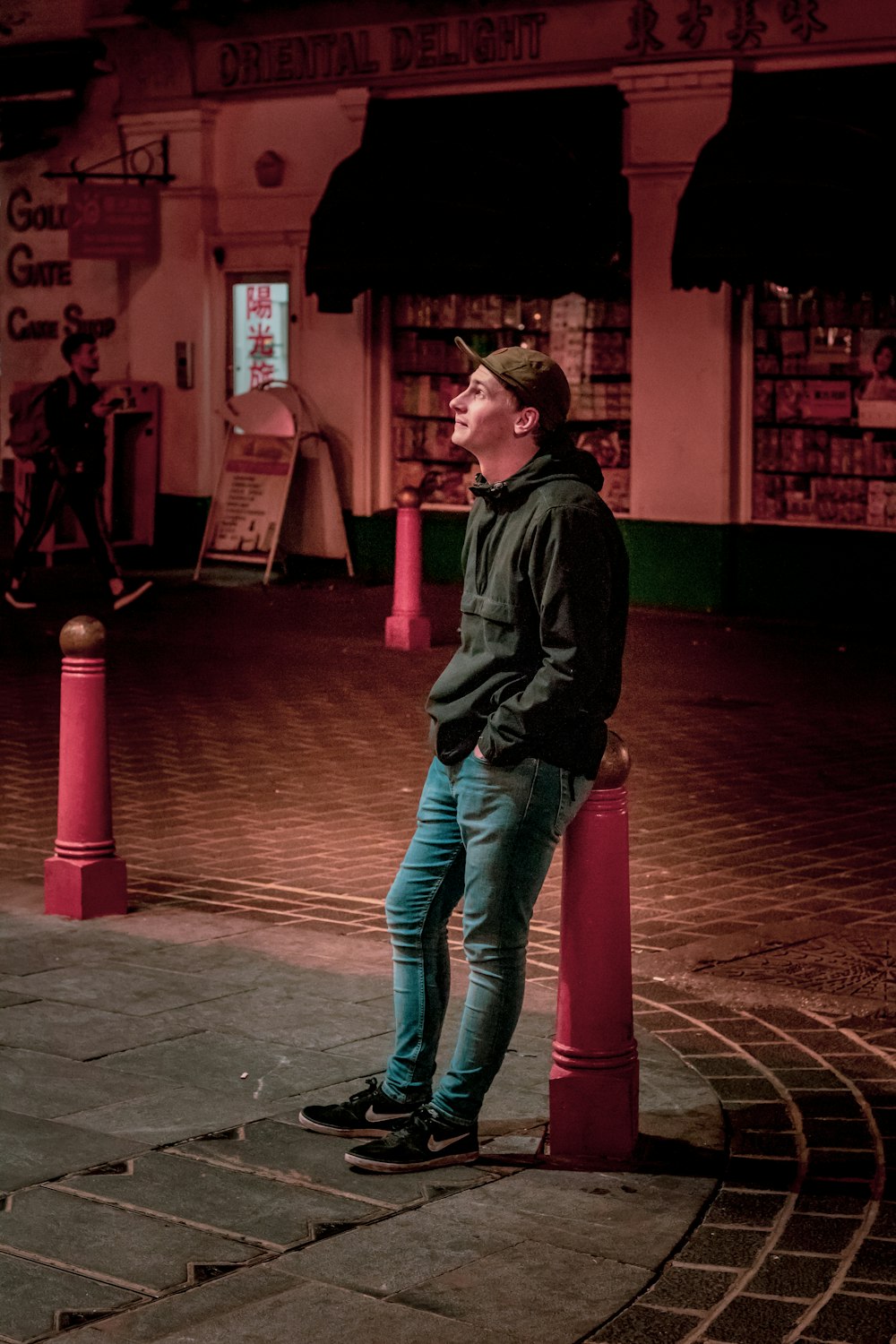 man standing at road during night time