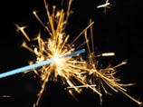 Close-up of colorful fireworks being ignited, sparks flying in slow motion.