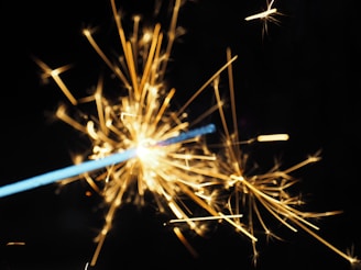 Close-up of golden sparks raining down from a powerful firework shell.
